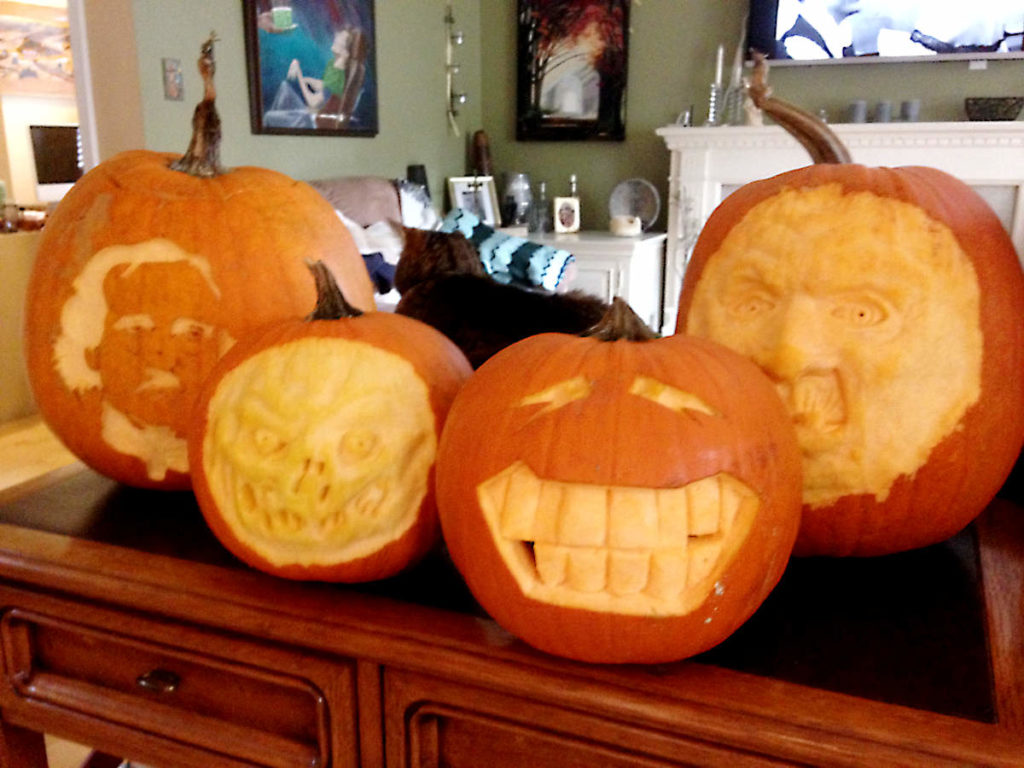Four pumpins, three 3D carved and one etched of Poe