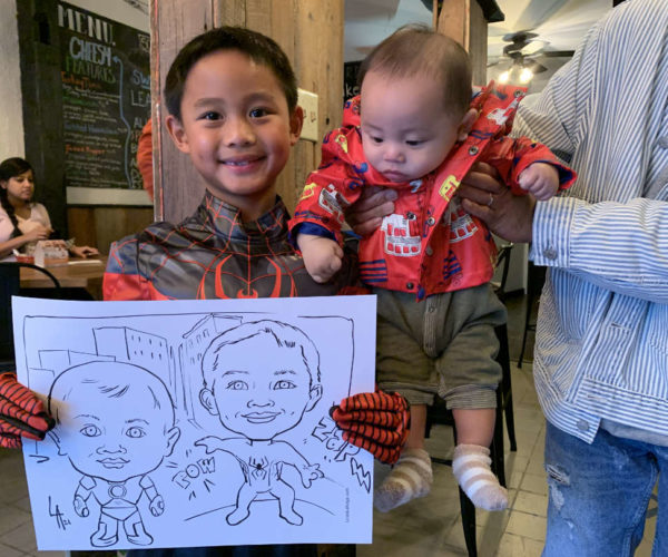 Caricature drawing of brothers kids on the spot at Culture Days