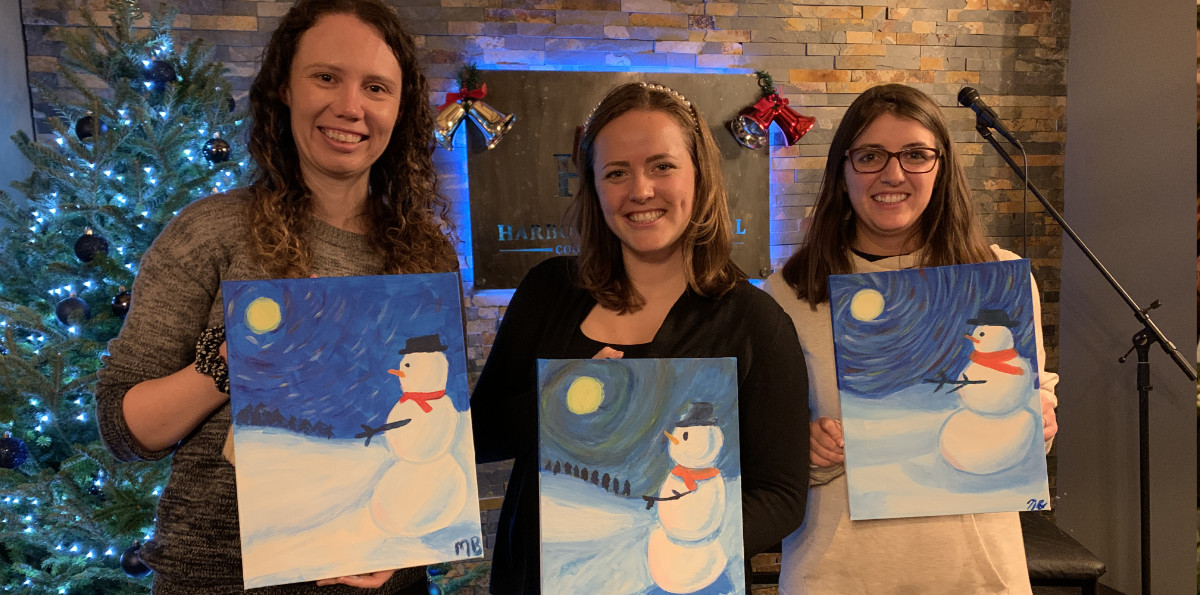 sip and paint night students showing off their awesome paintings