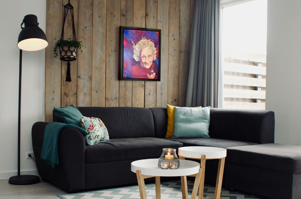 Mother Nature painting of her at the big bang, hanging over a couch in a livingroom