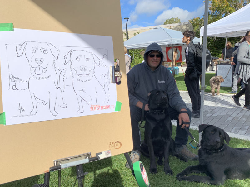 caricatures of dogs at an outdoor festival
