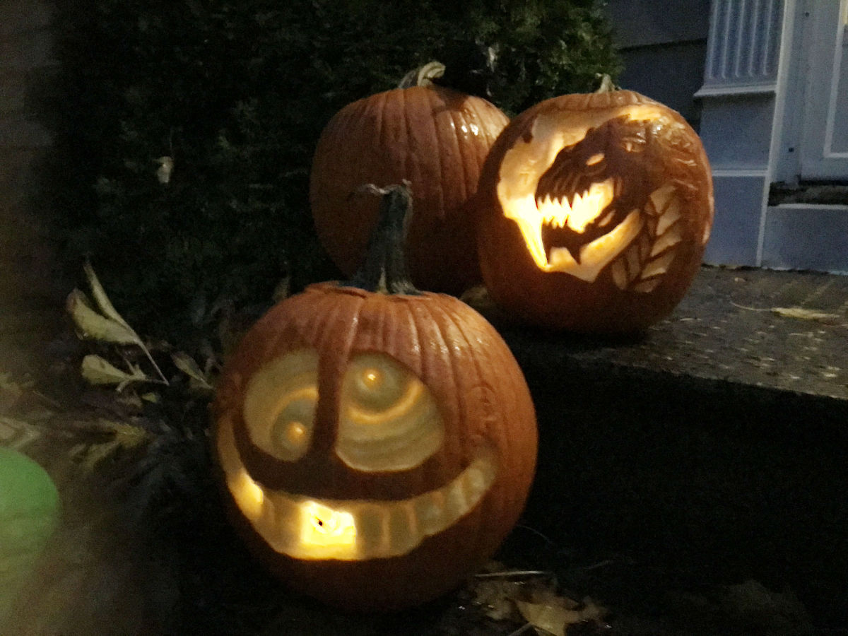 pumpkin etching - dragon and funny face pumpkins outside